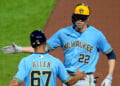 Milwaukee Brewers' Christian Yelich (22) celebrates with first base coach Spencer Allen after driving in two runs with a single off Pittsburgh Pirates pitcher Carmen Mlodzinski during the seventh inning of a baseball game in Pittsburgh, Wednesday, Sept. 16, 2026. (AP Photo/Gene J. Puskar)