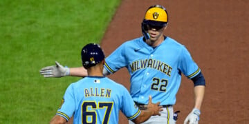 Milwaukee Brewers' Christian Yelich (22) celebrates with first base coach Spencer Allen after driving in two runs with a single off Pittsburgh Pirates pitcher Carmen Mlodzinski during the seventh inning of a baseball game in Pittsburgh, Wednesday, Sept. 16, 2026. (AP Photo/Gene J. Puskar)