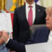 President Donald Trump holds up a chart as Arkansas Gov. Sarah Huckabee Sanders, from left, Mehmet Oz, administrator of the Centers for Medicare & Medicaid Services, and Health and Human Services Secretary Robert F. Kennedy Jr. listen during an event about healthcare in the Oval Office of the White House, Friday Sept. 18, 2026, in Washington. (AP Photo/Jacquelyn Martin)