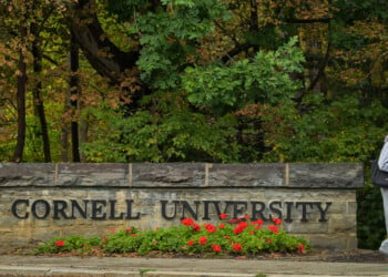 A student walks past a Cornell University sign in Ithaca, N.Y., Monday, Sept. 28, 2026. (AP Photo/Heather Ainsworth)