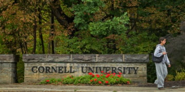 A student walks past a Cornell University sign in Ithaca, N.Y., Monday, Sept. 28, 2026. (AP Photo/Heather Ainsworth)