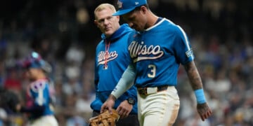 Milwaukee Brewers' Joey Ortiz exits the field with a trainer after suffering an injury during the eighth inning of a baseball game against the St. Louis Cardinals, Friday, Sept. 25, 2026, in Milwaukee. (AP Photo/Aaron Gash)