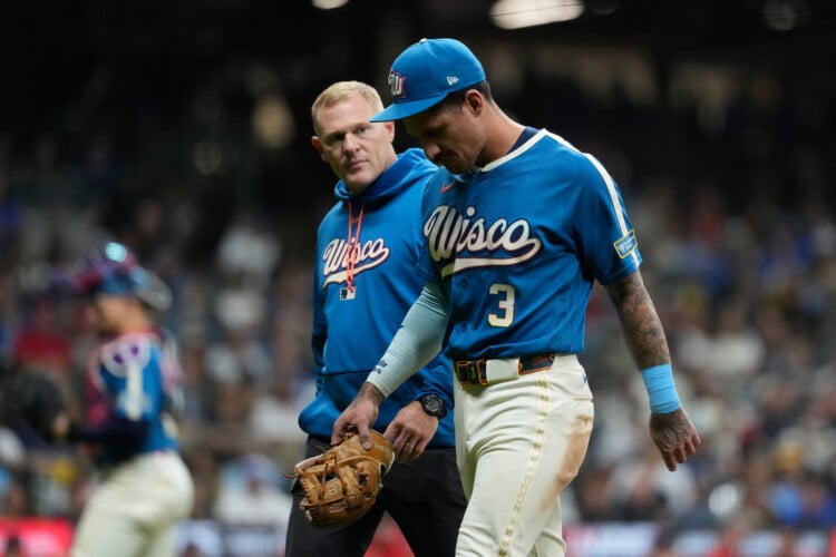 Milwaukee Brewers' Joey Ortiz exits the field with a trainer after suffering an injury during the eighth inning of a baseball game against the St. Louis Cardinals, Friday, Sept. 25, 2026, in Milwaukee. (AP Photo/Aaron Gash)