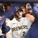 Brice Turang gets high fives in the dugout after hitting a home run at American Family Field.