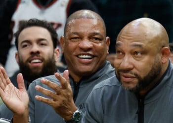 FILE - Milwaukee Bucks head coach Doc Rivers, center, applauds during the first half of an NBA basketball game against the Dallas Mavericks, March 31, 2026, in Milwaukee. (AP Photo/Jeffrey Phelps, File)