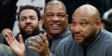 FILE - Milwaukee Bucks head coach Doc Rivers, center, applauds during the first half of an NBA basketball game against the Dallas Mavericks, March 31, 2026, in Milwaukee. (AP Photo/Jeffrey Phelps, File)