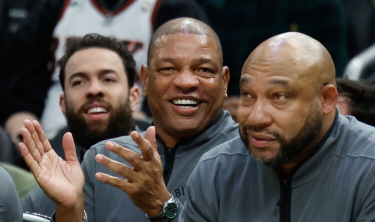 FILE - Milwaukee Bucks head coach Doc Rivers, center, applauds during the first half of an NBA basketball game against the Dallas Mavericks, March 31, 2026, in Milwaukee. (AP Photo/Jeffrey Phelps, File)