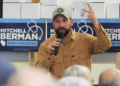 Democratic congressional candidate Mitchell Berman talks to supporters at Wilson's Coffee and Tea in Racine, Wis., Tuesday, Sept. 22, 2026.(AP Photo/Nam Y. Huh)