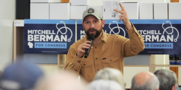 Democratic congressional candidate Mitchell Berman talks to supporters at Wilson's Coffee and Tea in Racine, Wis., Tuesday, Sept. 22, 2026.(AP Photo/Nam Y. Huh)
