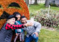 Family Takes A Selfie With Halloween Decor At The Swiss Historical Village Museum In New Glarus (Photo: Travel Wisconsin)