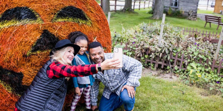 Family Takes A Selfie With Halloween Decor At The Swiss Historical Village Museum In New Glarus (Photo: Travel Wisconsin)
