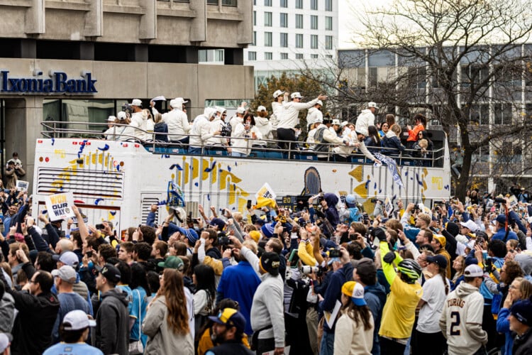 Brewers players wave to fans on top of their bus along the World Series Parade Route, October 30, 2026 (Photo: Nick Brown)