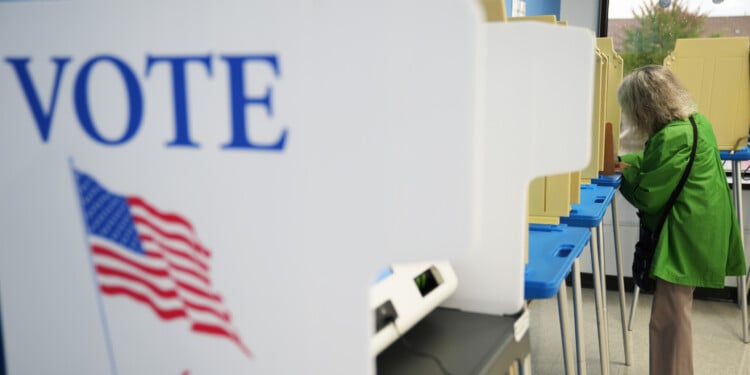A voter cast a ballot on the first day of early voting in Minnesota at the Elections & Voter Services building, Friday, Sept. 18, 2026, in Minneapolis. (AP Photo/Ellen Schmidt)