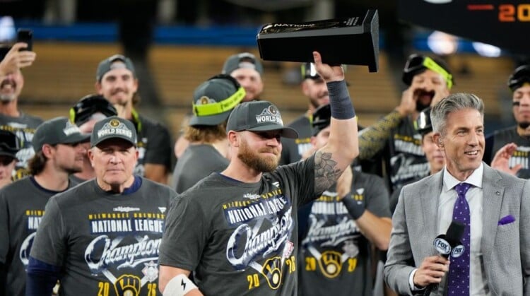 Milwaukee Brewers first baseman Jake Bauers hols the NLCS MVP trophy after Game 4 of baseball's National League Championship Series between the Milwaukee Brewers and the Los Angeles Dodgers, Thursday, Oct. 15, 2026, in Los Angeles. (AP Photo/Ashley Landis)