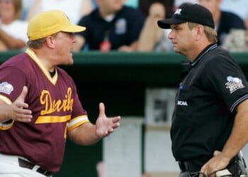 FILE - Arizona State coach Pat Murphy, left, protests to home plate umpire Jeff Henrichs after a balk call allowed UC Irvine's Taylor Holiday to score in the fourth inning of a College World Series baseball elimination game in Omaha, Neb., June 19, 2007. (AP Photo/Eric Francis, File)