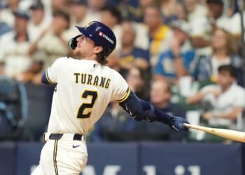 MILWAUKEE, WISCONSIN - OCTOBER 11: Brice Turang #2 of the Milwaukee Brewers hits a home run against the Los Angeles Dodgers during the fourth inning in game one of the National League Championship Series at American Family Field on October 11, 2026 in Milwaukee, Wisconsin. (Photo by John Fisher/Getty Images)