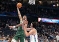 Milwaukee Bucks center Kel'el Ware, left, shoots over Oklahoma City Thunder center Aday Mara during the second half of an NBA basketball game, Wednesday, Oct. 7, 2026, in Oklahoma City. (AP Photo/Kyle Phillips)