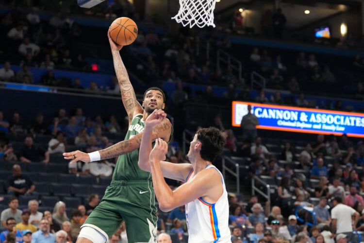 Milwaukee Bucks center Kel'el Ware, left, shoots over Oklahoma City Thunder center Aday Mara during the second half of an NBA basketball game, Wednesday, Oct. 7, 2026, in Oklahoma City. (AP Photo/Kyle Phillips)