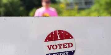 FILE - An, " I Voted Today," sticker is stuck to an information sign at Olbrich Gardens, Aug. 11, 2026, in Madison, Wis. (AP Photo/Nam Y. Huh, File)