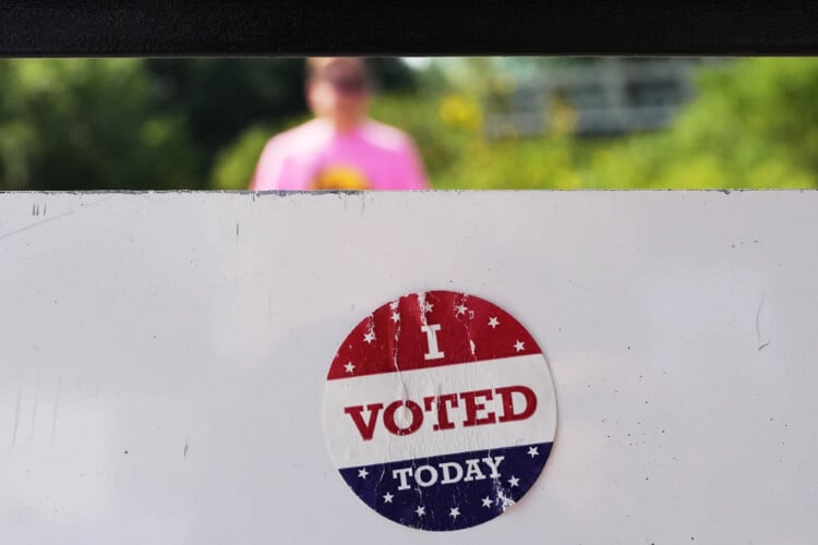 FILE - An, " I Voted Today," sticker is stuck to an information sign at Olbrich Gardens, Aug. 11, 2026, in Madison, Wis. (AP Photo/Nam Y. Huh, File)