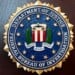 An FBI seal is displayed on a podium before a news conference at the field office in Portland, Ore., Jan. 16, 2025. (AP Photo/Jenny Kane, File)