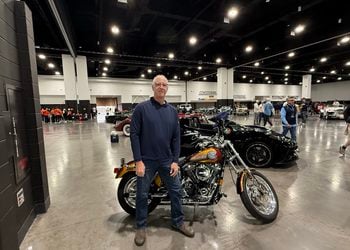 Bob Uecker Jr. stands in front of his father's motorcycle in the Baird Center before the Brewers Championship Parade. Uecker Jr. rode his father's former Harley during the parade on October 30, 2026 (Photo: Nazir Spencer)