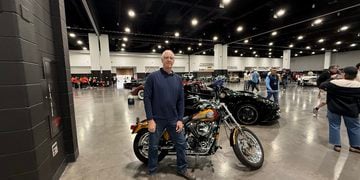 Bob Uecker Jr. stands in front of his father's motorcycle in the Baird Center before the Brewers Championship Parade. Uecker Jr. rode his father's former Harley during the parade on October 30, 2026 (Photo: Nazir Spencer)