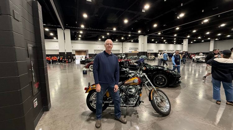 Bob Uecker Jr. stands in front of his father's motorcycle in the Baird Center before the Brewers Championship Parade. Uecker Jr. rode his father's former Harley during the parade on October 30, 2026 (Photo: Nazir Spencer)