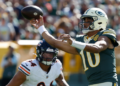 Green Bay Packers' Jordan Love throws past Chicago Bears' Austin Booker during the first half of an NFL football game in Green Bay, Wis., Sunday, Oct. 11, 2026. (AP Photo/Mike Roemer)