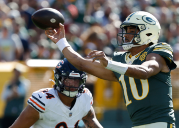 Green Bay Packers' Jordan Love throws past Chicago Bears' Austin Booker during the first half of an NFL football game in Green Bay, Wis., Sunday, Oct. 11, 2026. (AP Photo/Mike Roemer)