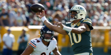 Green Bay Packers' Jordan Love throws past Chicago Bears' Austin Booker during the first half of an NFL football game in Green Bay, Wis., Sunday, Oct. 11, 2026. (AP Photo/Mike Roemer)