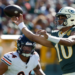 Green Bay Packers' Jordan Love throws past Chicago Bears' Austin Booker during the first half of an NFL football game in Green Bay, Wis., Sunday, Oct. 11, 2026. (AP Photo/Mike Roemer)