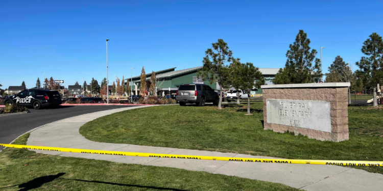 Police tape is placed outside Silver Rail Elementary school, where a shooting took place, on Thursday, Oct. 15, 2026 in Bend, Ore. (AP Photo/Joe Kline)