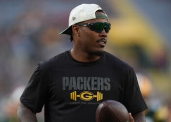 FILE - Green Bay Packers running back Josh Jacobs stands on the field before a preseason NFL football game against the Arizona Cardinals, Aug. 28, 2026, in Green Bay, Wis. (AP Photo/Abbie Parr, File)