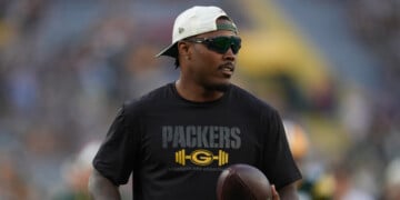 FILE - Green Bay Packers running back Josh Jacobs stands on the field before a preseason NFL football game against the Arizona Cardinals, Aug. 28, 2026, in Green Bay, Wis. (AP Photo/Abbie Parr, File)