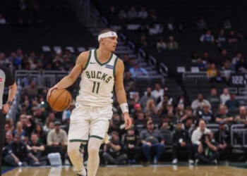 Milwaukee Bucks' guard Tyler Herro, left, brings the ball up the court against Minnesota Timberwolves forward Jaden McDaniels', right, during a preseason NBA basketball game Monday, Oct. 5, 2026, in Milwaukee. (AP Photo/Kylie Bridenhagen)