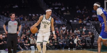 Milwaukee Bucks' guard Tyler Herro, left, brings the ball up the court against Minnesota Timberwolves forward Jaden McDaniels', right, during a preseason NBA basketball game Monday, Oct. 5, 2026, in Milwaukee. (AP Photo/Kylie Bridenhagen)