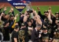 Milwaukee Brewers designated hitter Christian Yelich holds the World Series trophy with teammates after winning baseball's World Series, against the Tampa Bay Rays, Wednesday, Oct. 28, 2026, in St. Petersburg, Fla. (AP Photo/Morry Gash)