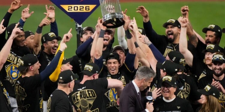 Milwaukee Brewers designated hitter Christian Yelich holds the World Series trophy with teammates after winning baseball's World Series, against the Tampa Bay Rays, Wednesday, Oct. 28, 2026, in St. Petersburg, Fla. (AP Photo/Morry Gash)