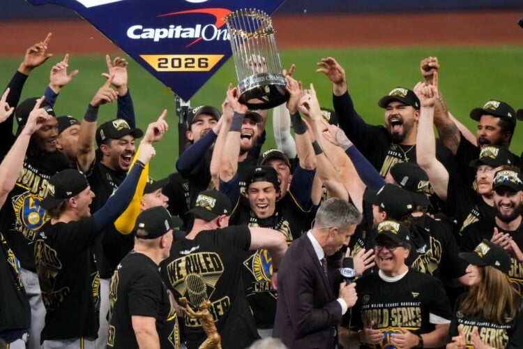 Milwaukee Brewers designated hitter Christian Yelich holds the World Series trophy with teammates after winning baseball's World Series, against the Tampa Bay Rays, Wednesday, Oct. 28, 2026, in St. Petersburg, Fla. (AP Photo/Morry Gash)