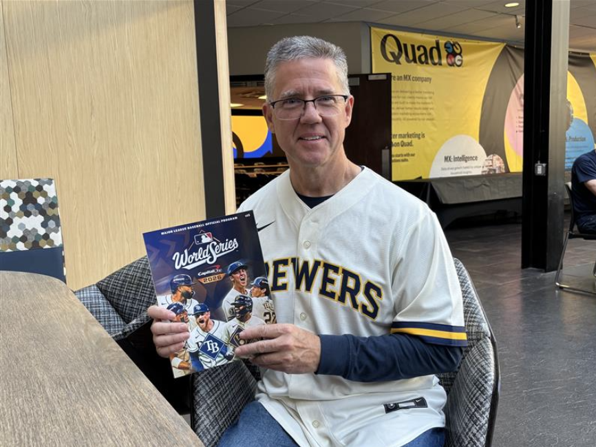 Quad's Customer Service Manager for Major League Baseball Rick Cowan holds a copy of the official 2026 World Series program printed at the company's Sussex facility. October 20, 2026. Image Credit: Adam Roberts